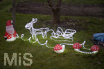 01.12.2020,  Weihnachts-Dekoration in einem Garten in Bayern. Ein Rentier mit Schlitten und ein Weihnachtsmann stehen im Garten ohne Schnee. 