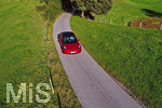10.10.2021,  Ein roter Tesla Model 3 fhrt auf einer Landstrasse bei Kempten im Allgu.