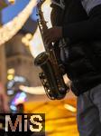 20.11.2023, Hauptstadt Wien (Österreich) erstrahlt im vorweihnachtlichem Glanz, impressionen vom Stephansplatz, Ein Strassenmusiker spielt mit seinem Saxophon unter funkelndem Lichterschein.