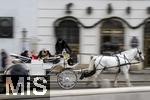 21.11.2023, Österreich, die Hauptstadt Wien. Ein Fiaker fährt Touristen durch die malerische Altstadt.