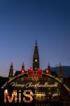 21.11.2023, sterreich, die Hauptstadt Wien. Impressionen vom Weihnachtsmarkt vor dem festlich beleuchteten Rathaus im Abendlicht. Hier das groe Eingangstor mit einem Karussell. 