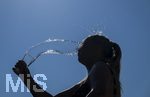 24.06.2026, Sommerhitze in Deutschland, Mindelheim im Unterallgäu, eine Frau erfrischt sich mit einem schwall kaltem Wasser in ihr Gesicht. (Modelrelased)  