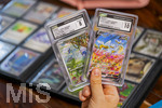 05.08.2026, Deutschland, Bayern, Pokemon-Sammelkarten, eine Teenagerin sammelt begeistert Pokemon-Karten.  
