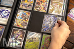 05.08.2026, Deutschland, Bayern, Pokemon-Sammelkarten, eine Teenagerin sammelt begeistert Pokemon-Karten in ihrem Sammelheft.