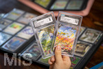 05.08.2026, Deutschland, Bayern, Pokemon-Sammelkarten, eine Teenagerin sammelt begeistert Pokemon-Karten. 