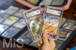 05.08.2026, Deutschland, Bayern, Pokemon-Sammelkarten, eine Teenagerin sammelt begeistert Pokemon-Karten. 