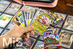 05.08.2026, Deutschland, Bayern, Pokemon-Sammelkarten, eine Teenagerin sammelt begeistert Pokemon-Karten in ihrem Sammelheft.   