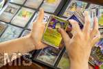 05.08.2026, Deutschland, Bayern, Pokemon-Sammelkarten, eine Teenagerin sammelt begeistert Pokemon-Karten in ihrem Sammelheft. 