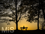 11.08.2026, Bad Wörishofen im Unterallgäu, Sonnenuntergangsstimmung am Ostpark, eine Frau geniesst die Aussicht von einer Bank am Ortsrand der Kneippstadt. Am Mittwoch ist Sonnenfinsternis (12.08.2026), da ist dieser Punkt optimal für die Beobachtung des Himmelsereignisses.
