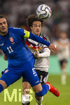 01.10.2026, Fussball UEFA Nations-League 2026/2027, 3.Spieltag, Deutschland - Serbien, in der Allianz-Arena München. Mika Baur (Deutschland) gegen Filip Kostic (Serbien) 